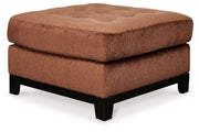 Ashley® Laylabrook oversized plush accent ottoman in spice with dark wood trim, square shape and soft fabric upholstery.