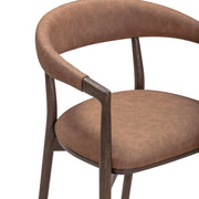Vina vegan leather dining arm chair by TOV Furniture with a sleek modern design and cushioned seat in a contemporary setting.