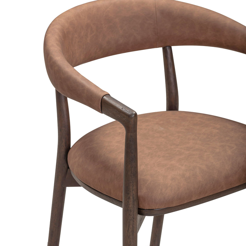 Vina vegan leather dining arm chair by TOV Furniture with a sleek modern design and cushioned seat in a contemporary setting.