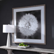 Framed print of dandelion seedhead in black by Uttermost, showcasing delicate seed details on a neutral background.