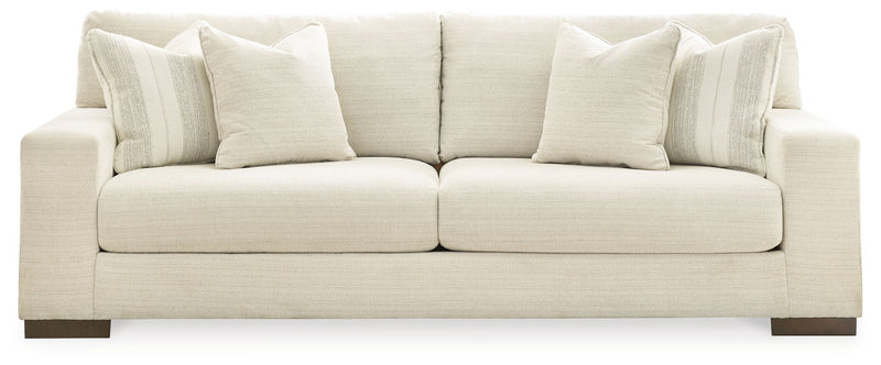 Signature Design by Ashley Maggie stationary living room set with a cozy chair and ottoman in neutral fabric.