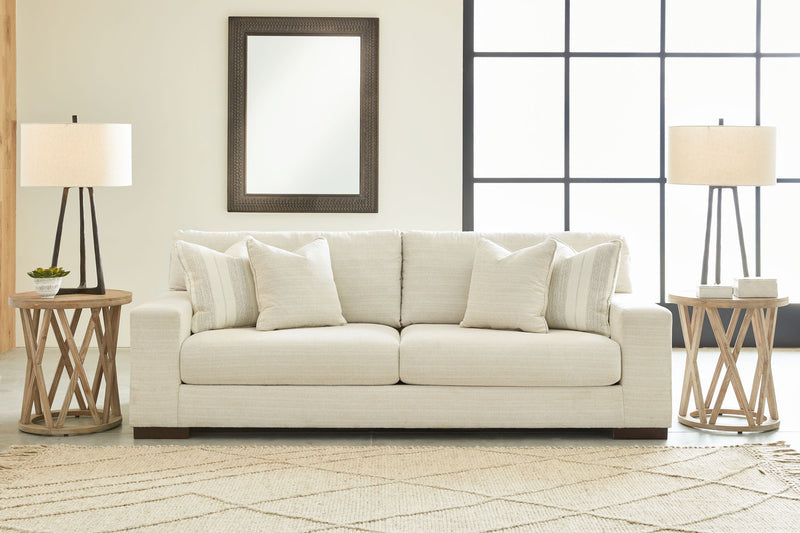 Signature Design by Ashley Maggie living room set with stationary chair and matching ottoman, featuring plush upholstery and modern style.