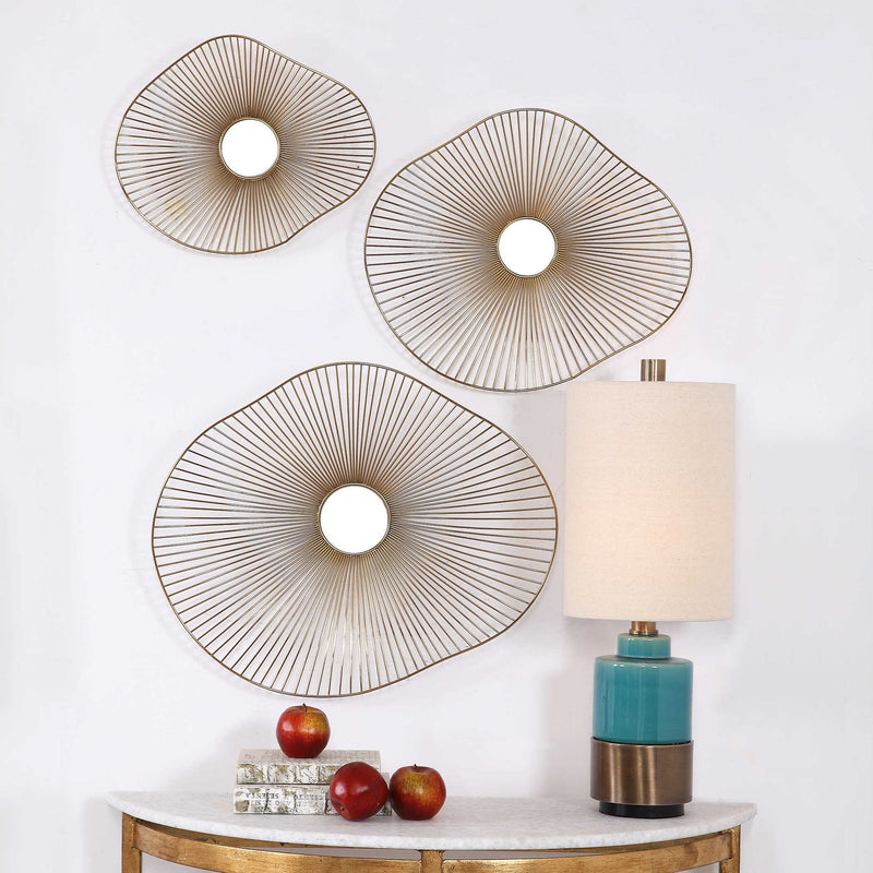 Set of three gold metal wall art pieces by Uttermost, modern abstract wall decor with geometric shapes for stylish home decoration.
