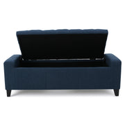 Noble House Guernsey storage ottoman with tufted top and wooden legs, used as a stylish, versatile furniture piece for living rooms.