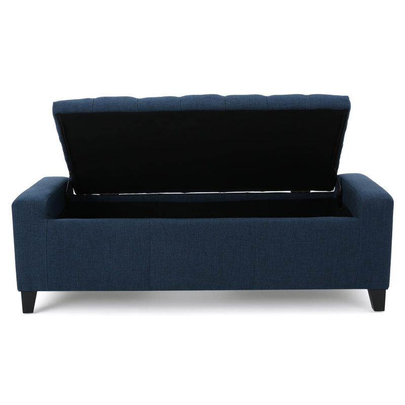 Noble House Guernsey storage ottoman with tufted top and wooden legs, used as a stylish, versatile furniture piece for living rooms.