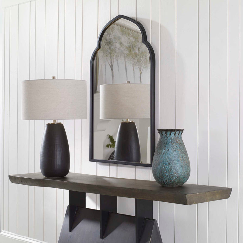 Uttermost Kenitra arched mirror with a sleek frame, showcasing a stylish and elegant design suitable for modern interior decor.