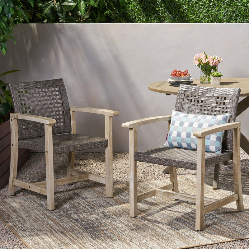 Set of two outdoor dining chairs with acacia wood frames by Noble House, featuring a sturdy design and natural wood finish.