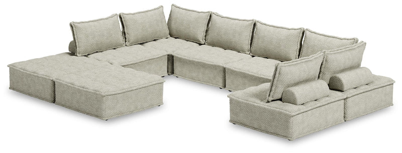 Signature Design by Ashley stationary sectional with plush beige fabric and wide armrests, perfect for modern living rooms.