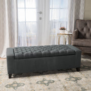 Dark gray Noble House storage ottoman with tufted top, featuring a contemporary design and functional storage space.