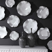 Set of three ceramic wall decor pieces by Uttermost featuring textured, artistic designs for modern interior decoration.