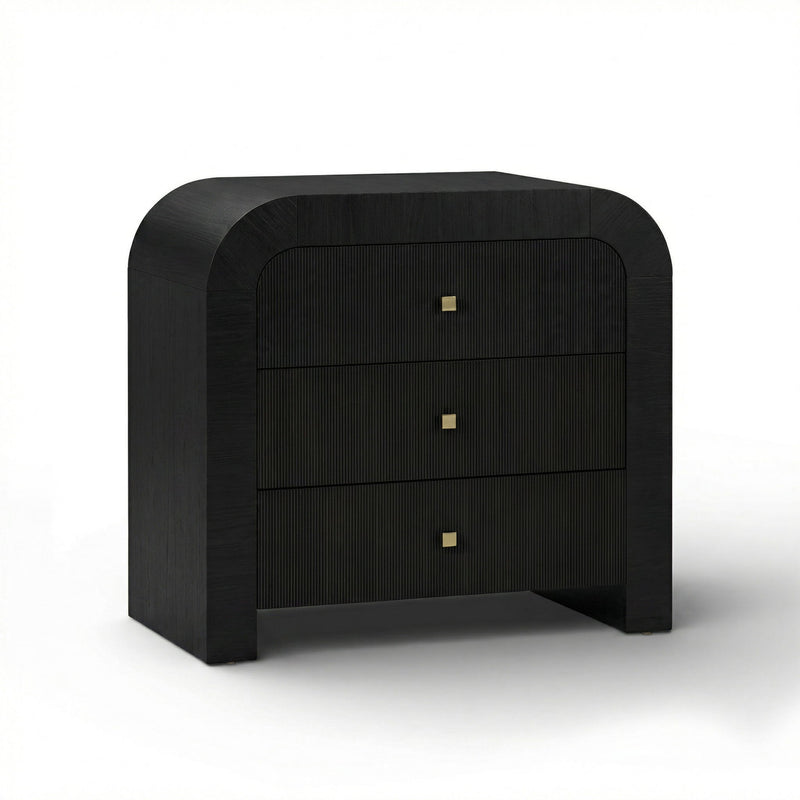 TOV Furniture Hump bedside chest with two drawers and sleek modern design, placed next to a bed in a contemporary bedroom setting.