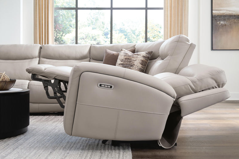 Benchcraft® Gravier reclining sectional with padded cushions and plush fabric, shown in a modern living room setting.
