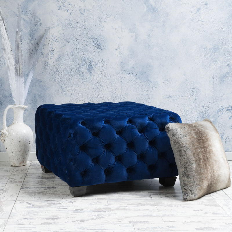 Noble House modern glam upholstered ottoman with button tufted design, soft fabric and stylish decor accents.