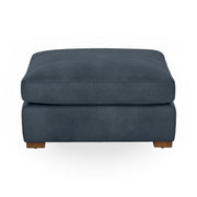Classic Home Audrey upholstered ottoman with cushioned top and wooden legs, ideal as a versatile living room accent piece.