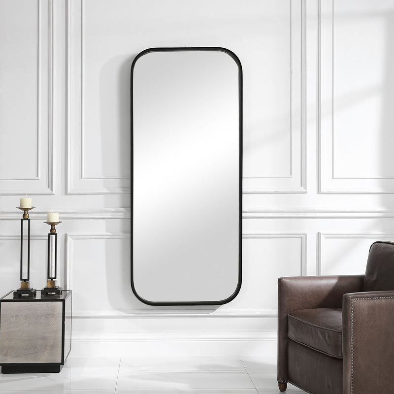 Black tall iron wall mirror by Uttermost with a sleek, minimalist frame, perfect for modern interior decor.