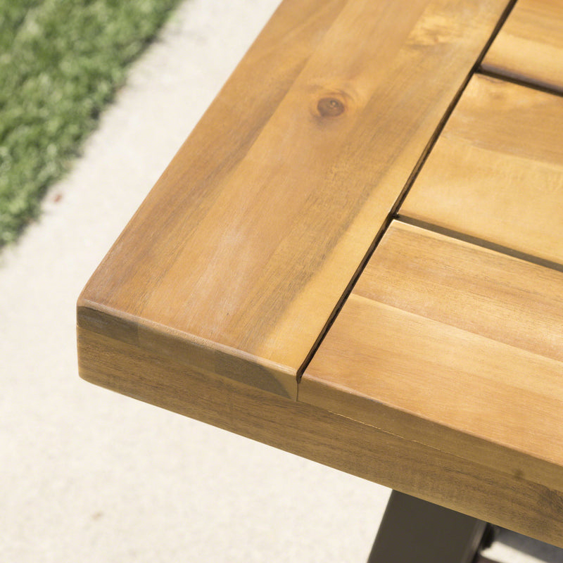 Outdoor teak and black metal backless dining bench by Noble House, ideal for patio seating.