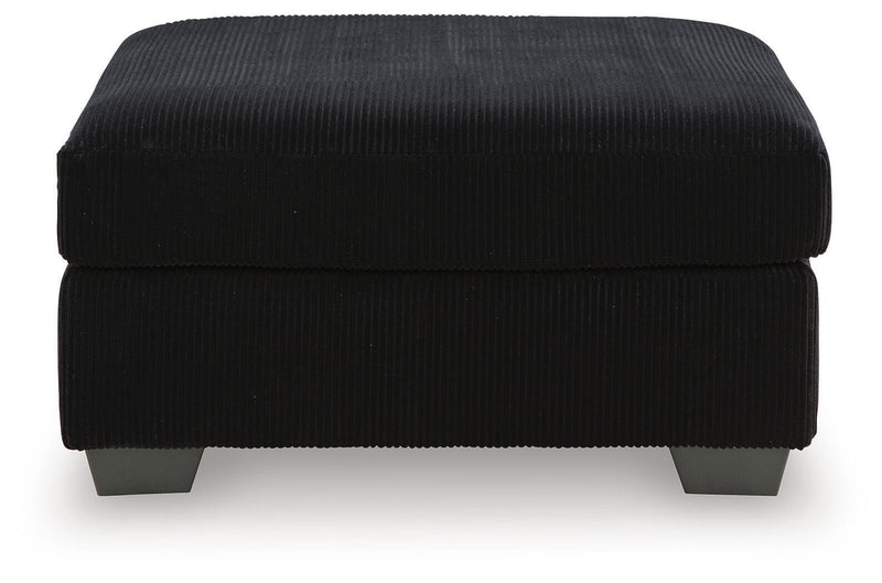 SimpleJoy oversized accent ottoman by Signature Design Ashley, showing a plush, beige fabric with a sturdy wooden base.