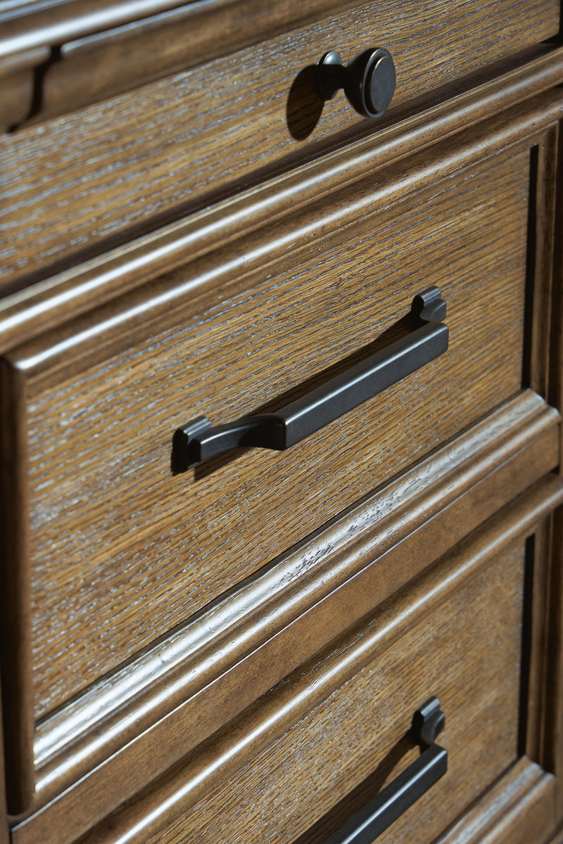 Medium brown Karallin seven drawer chest by Signature Design Ashley, featuring clean lines and a functional accent chest design.