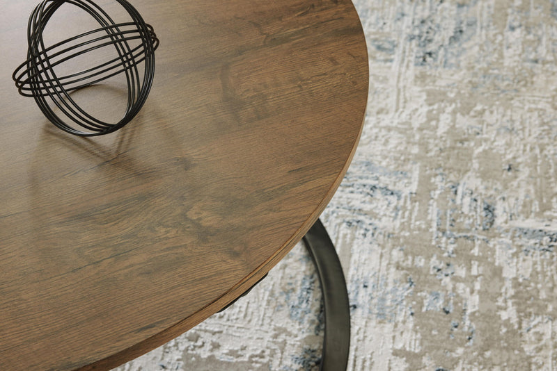 Set of three Signature Design by Ashley Cassbryn occasional tables in brown and black with modern, sleek tabletop designs.