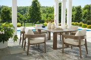 Seven-piece outdoor dining set by Signature Design Ashley, featuring a table with six chairs in a serene bay setting.