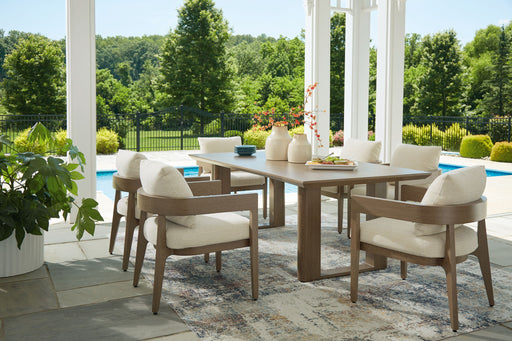 Seven-piece outdoor dining set by Signature Design Ashley, featuring a table with six chairs in a serene bay setting.