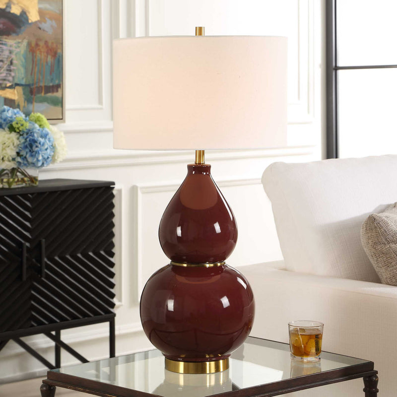 Uttermost gourd-shaped table lamp with a textured base and fabric shade, stylish accent for living or bedroom decor.