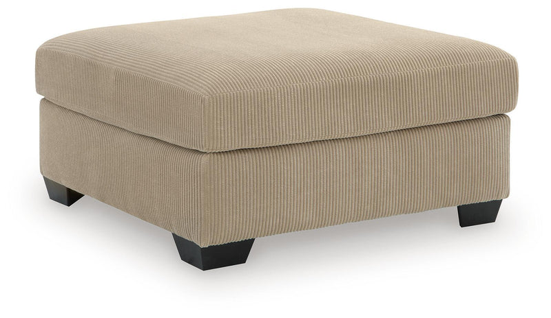 Signature Design by Ashley SimpleJoy oversized accent ottoman in neutral fabric, showing its plush, versatile design for living rooms.