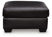 Midnight upholstered ottoman from Signature Design by Ashley, featuring a plush fabric and versatile seating or footrest functionality.