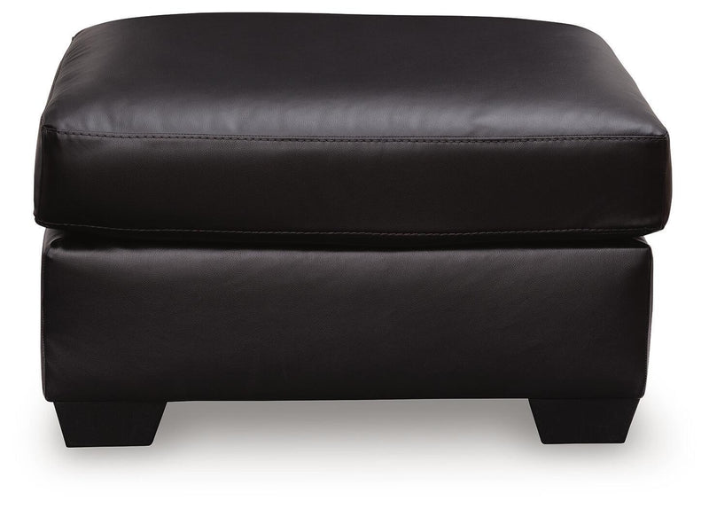 Midnight upholstered ottoman from Signature Design by Ashley, featuring a plush fabric and versatile seating or footrest functionality.