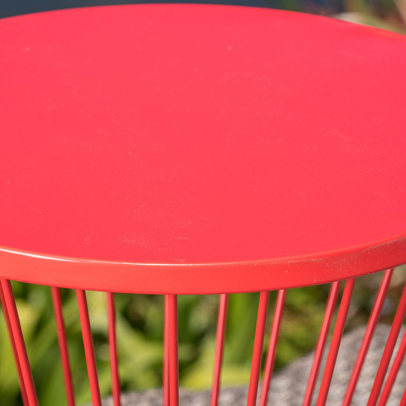 Noble House Lassen modern outdoor side table with a sleek hourglass design, featuring a metal frame and glass top.