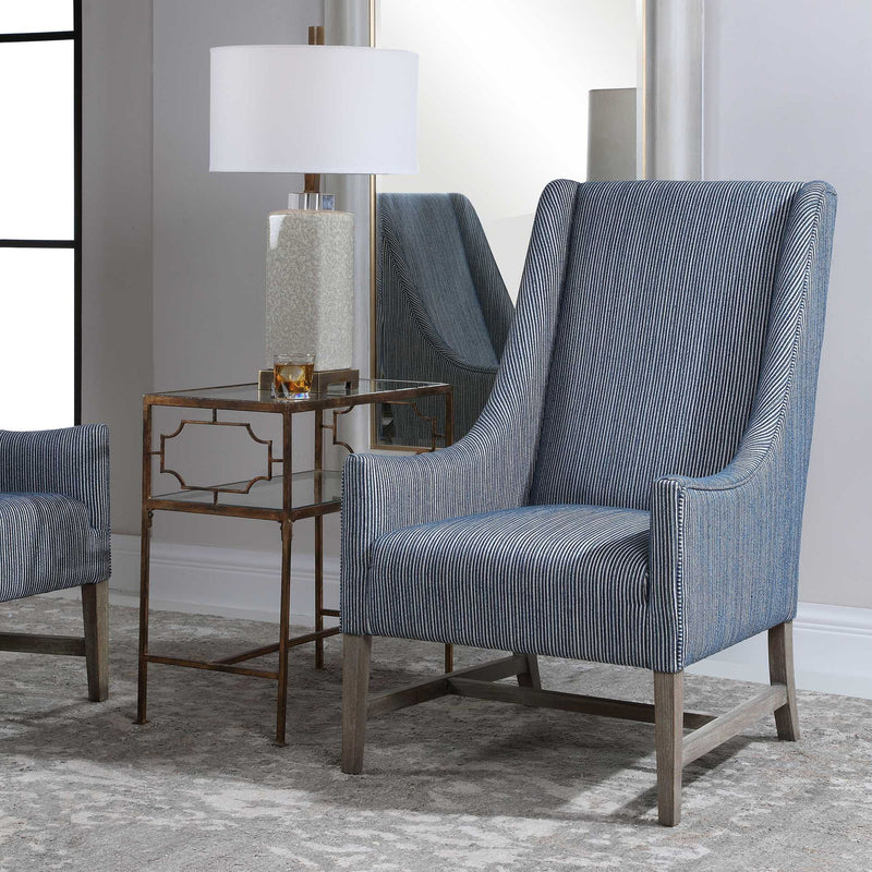 Blue Uttermost Galiot Wingback Accent Chair with tall back and wooden legs, showcasing elegant design and plush upholstery.