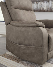 Signature Design by Ashley Crestmeade Power Lift Recliner in plush fabric with padded armrests and a reclining back.