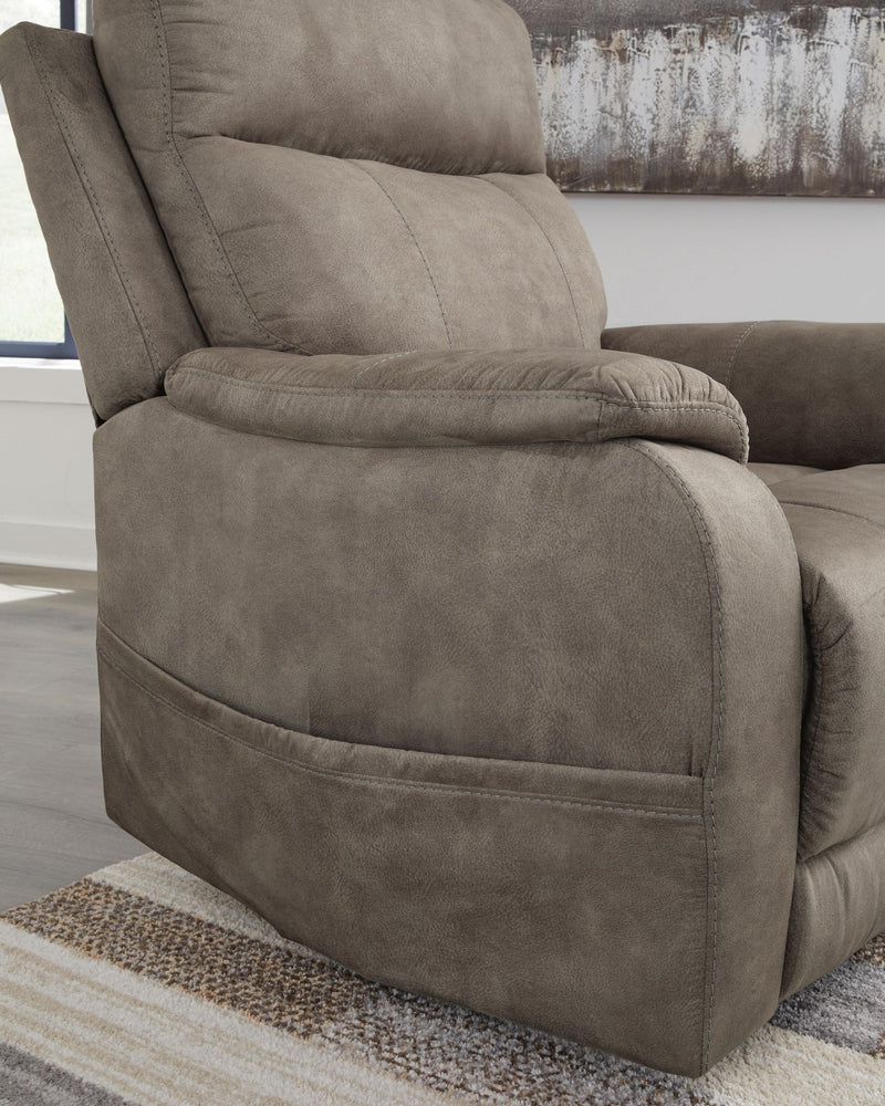 Signature Design by Ashley Crestmeade Power Lift Recliner in plush fabric with padded armrests and a reclining back.