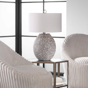 Uttermost Cyprien gray and white table lamp with a modern ceramic base and fabric shade, perfect for contemporary decor.