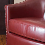 Noble House Enigmatica upholstered club arm chair with nailhead trim and plush cushioning, showcasing classic design and elegant details.