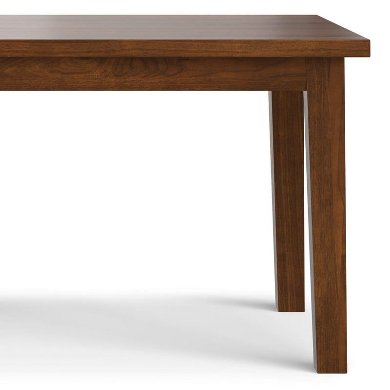 Simpli-Home Eastwood handcrafted wooden dining table with sturdy legs and smooth surface, ideal for family meals and gatherings.
