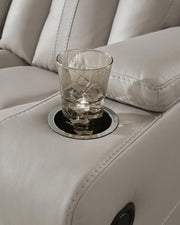 Signature Design by Ashley Elevate Edges Glider Recliner in Coin fabric, featuring plush cushioning and a smooth gliding mechanism.