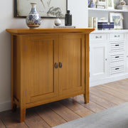 Redmond handcrafted low storage accent cabinet by Simpli-Home with a rustic wood finish and multiple storage compartments.