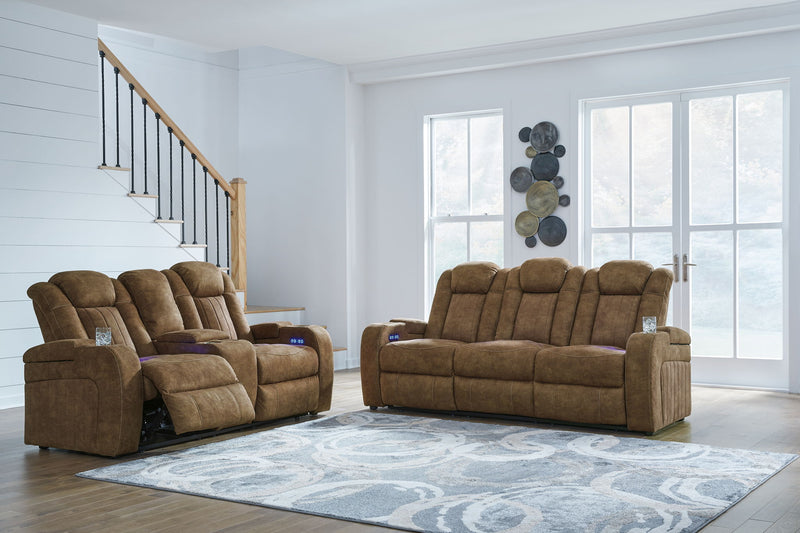Signature Design by Ashley Wolfridge 2-piece power reclining sofa and loveseat with console in brindle fabric, showing cushioned seats and armrests.