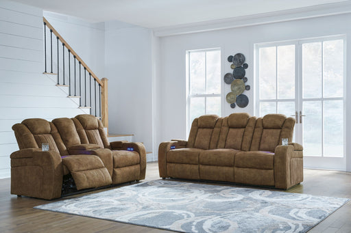 Signature Design by Ashley Wolfridge 2-piece power reclining sofa and loveseat with console in brindle fabric, showing cushioned seats and armrests.