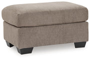 Benchcraft® upholstered Ottoman with plush fabric, featuring a rectangular shape and tufted top for stylish comfort.