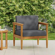 Outdoor Noble House patio arm chair with dark gray cushions and teak acacia wood frame, perfect for outdoor relaxation.
