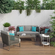 Simpli-Home Carmel outdoor conversation arm chair in Sand Drift color with cushioned seat and armrests, suitable for patio seating.