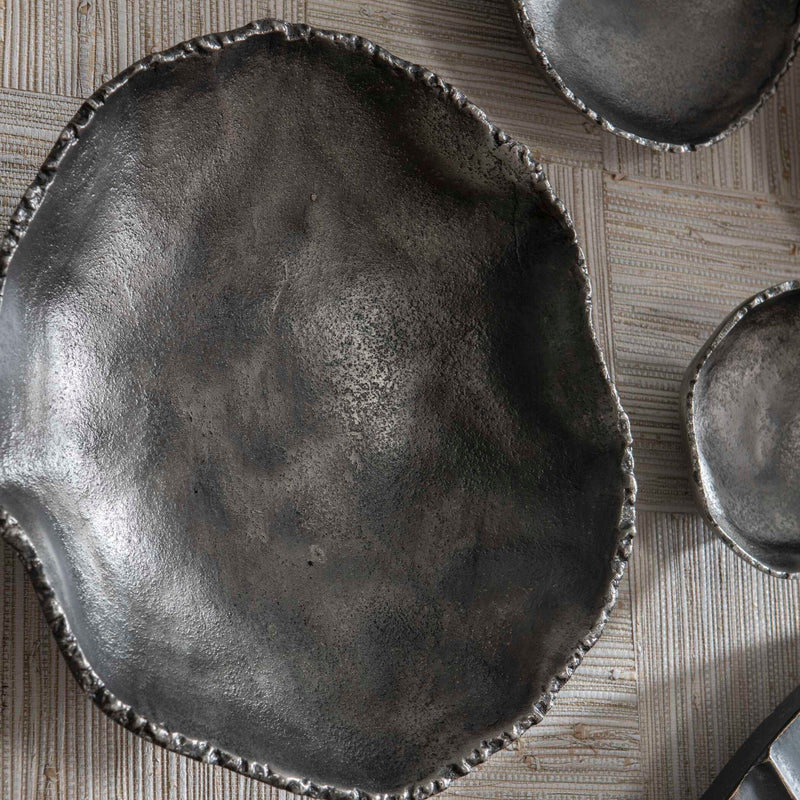 Set of four Uttermost Lucky Coins wall decor bowls with metallic finishes and intricate patterns, arranged on a neutral background.
