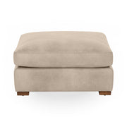 Classic Home Audrey upholstered ottoman with cushioned top and wooden legs, perfect for living room decor.