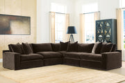 Benchcraft® Maxton Heights stationary sectional sofa with plush cushions and modern design, shown in a cozy living room setting.