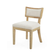 Set of two Noble House farmhouse style fabric upholstered side dining chairs with wooden legs on a neutral background.