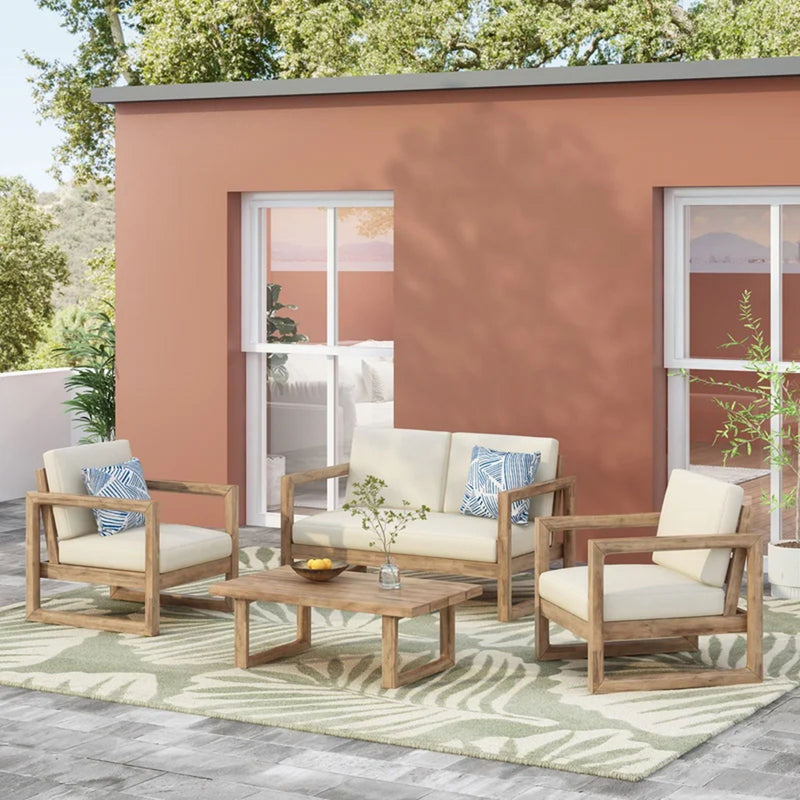 Noble House 4-piece acacia wood outdoor patio furniture set with soft cushions, includes porch chairs and coffee table in brown wash and beige.