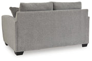 Benchcraft stationary loveseat with plush cushions and modern design, perfect for comfortable seating in living rooms.