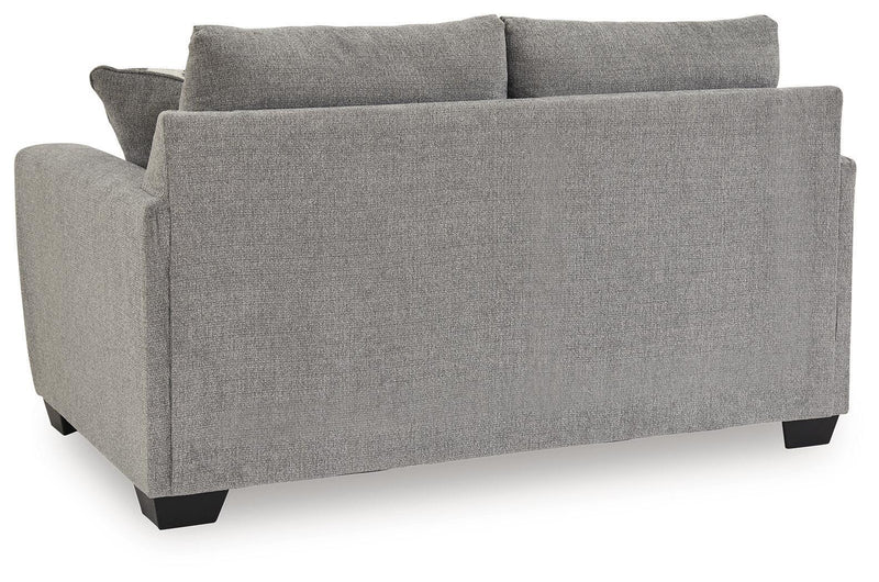 Benchcraft stationary loveseat with plush cushions and modern design, perfect for comfortable seating in living rooms.